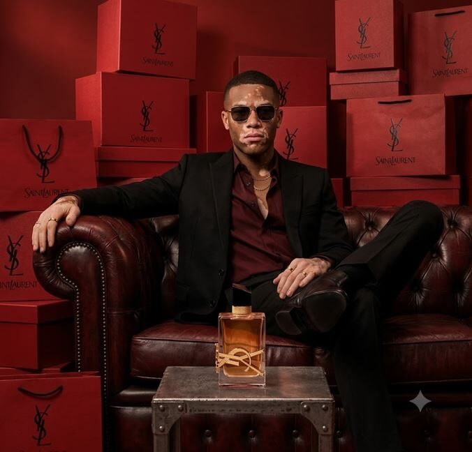 Him on a burgundy Chesterfield surrounded by red boxes